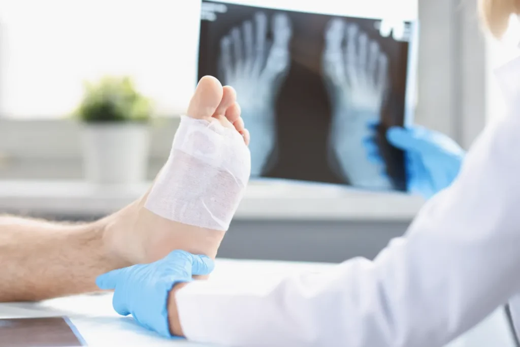 A physician examining a patients wrapped foot