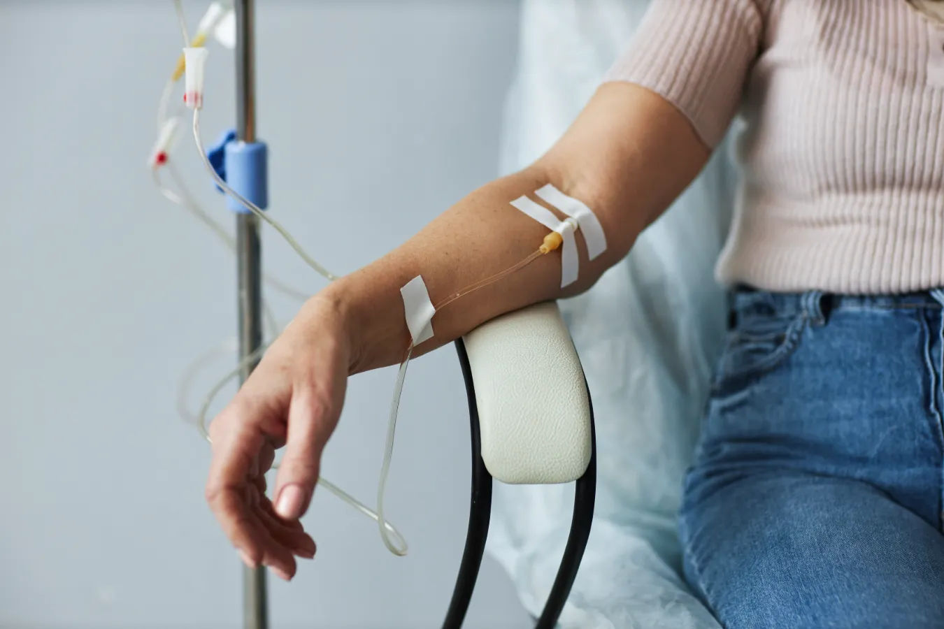 A patient with arm on chair with an iv