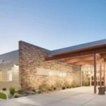 Newport Health Center building in early evening with lights on