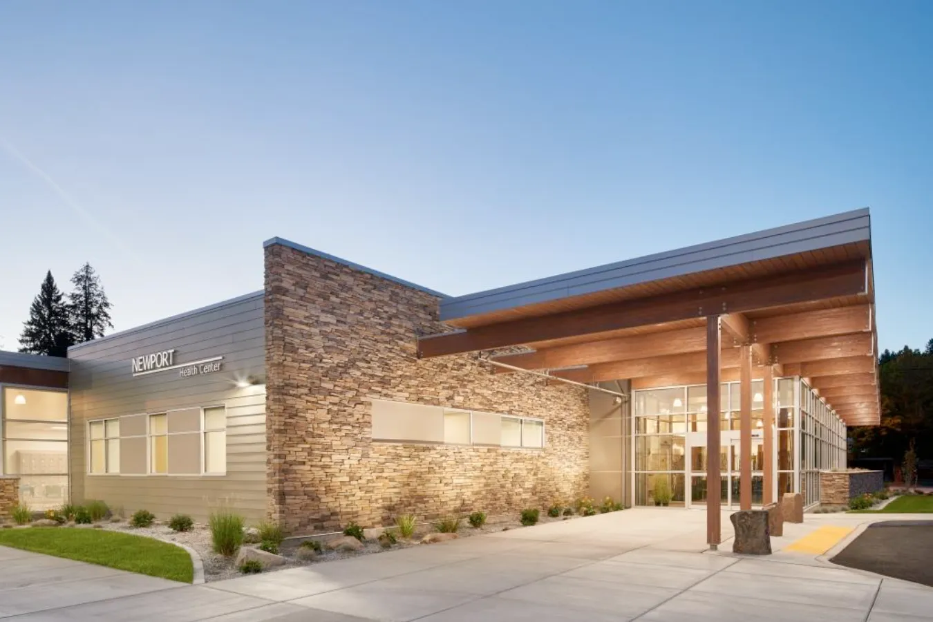 Newport Health Center building in early evening with lights on