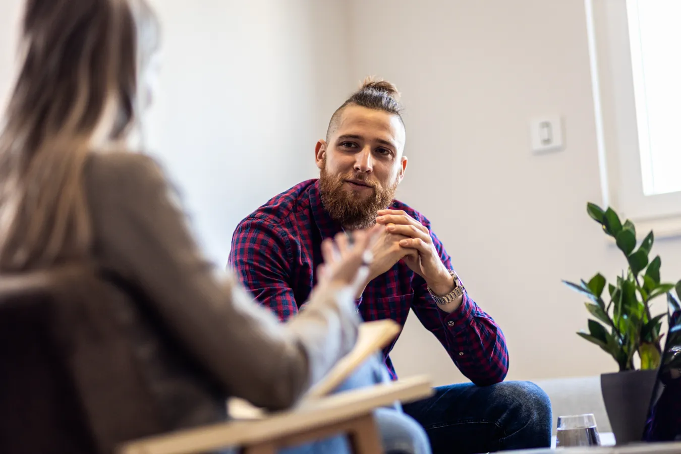 A younger male sitting across from a medical professional having a conversation